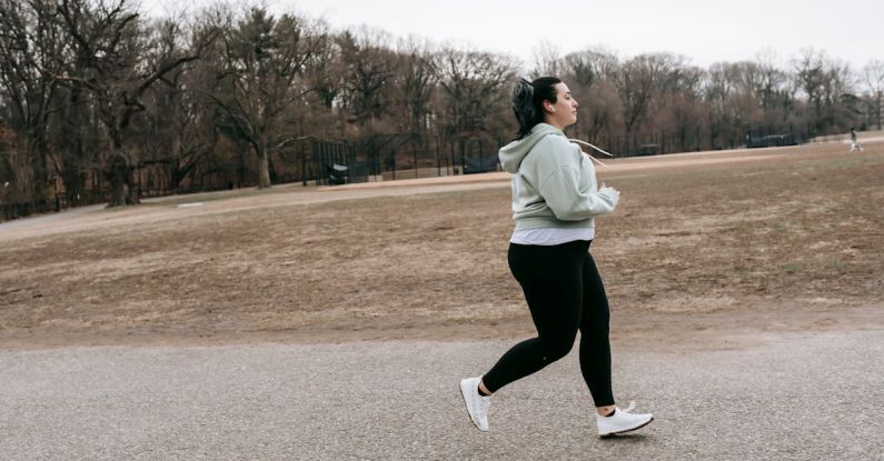 Energy Audit - Plus size woman running in autumn park