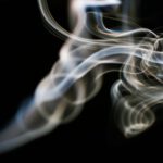 Smoke Detectors - a blurry photo of smoke on a black background