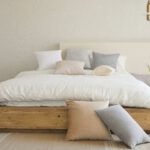 Minimalist Decor - white bed pillow on brown wooden bed frame