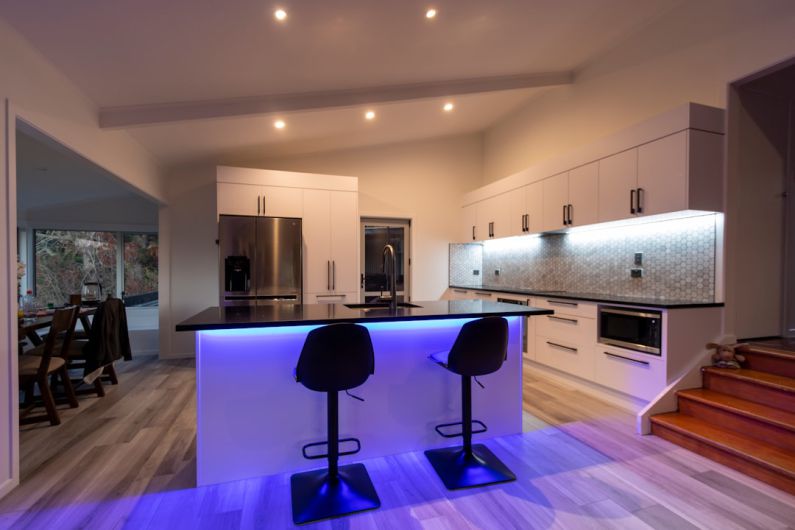 LED Lighting - black and purple chairs on brown wooden floor