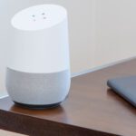 Home Automation - white and gray Google home on brown table